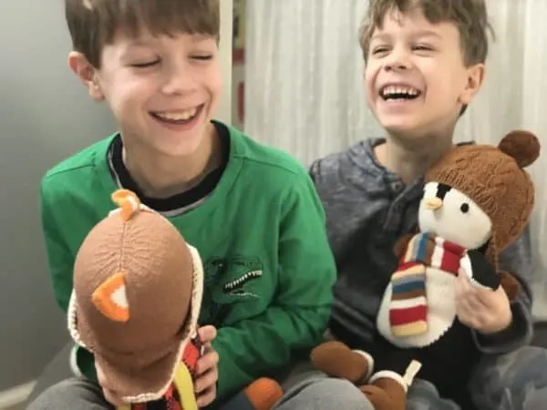 A young boy holding a teddy bear