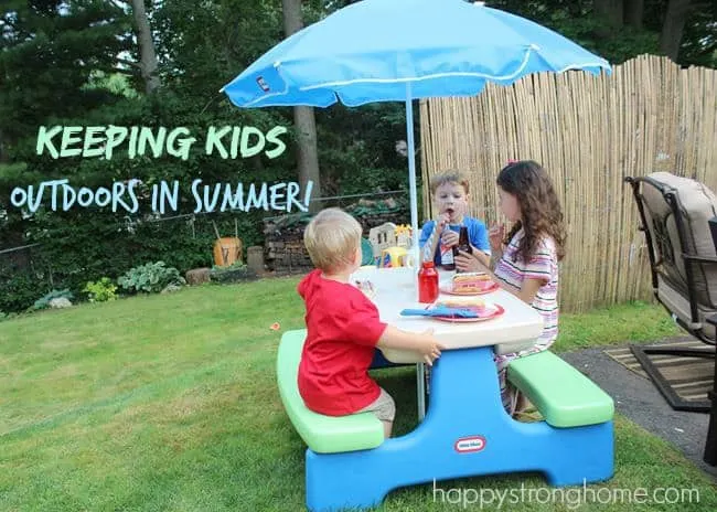 Kids outdoors at a plastic picnic table