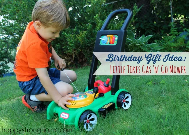 Boy in the yard with toy mower