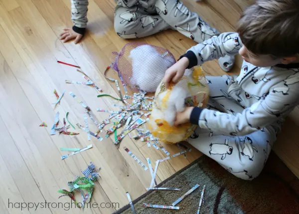 Boy sitting on floor building a nesting bag