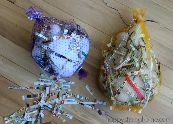 Two bags stuffed with cotton and shredded paper on floor