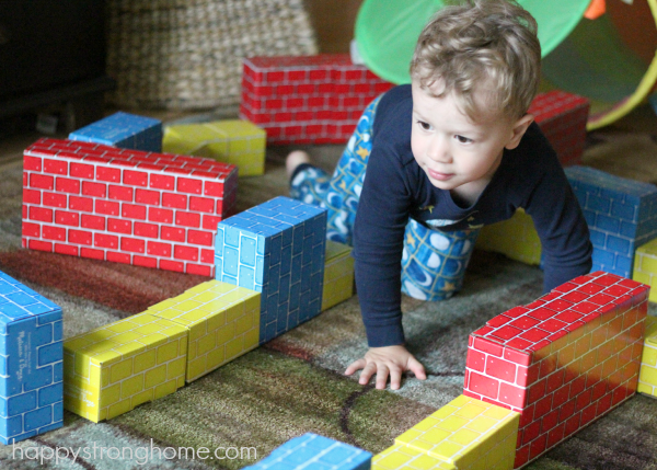 Child playing with cardboard blocks