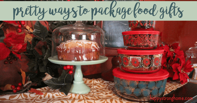 Cake on stand with snacks in plastic containers on table