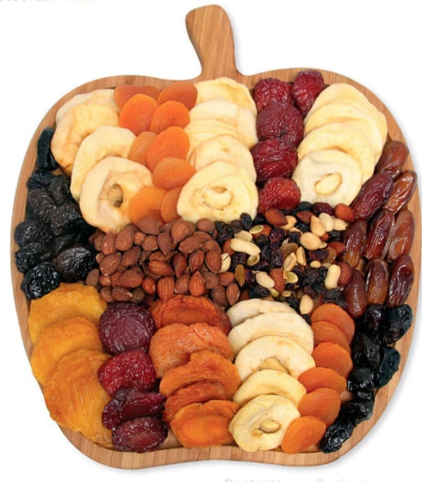 Fruits and nuts on apple shaped cutting board