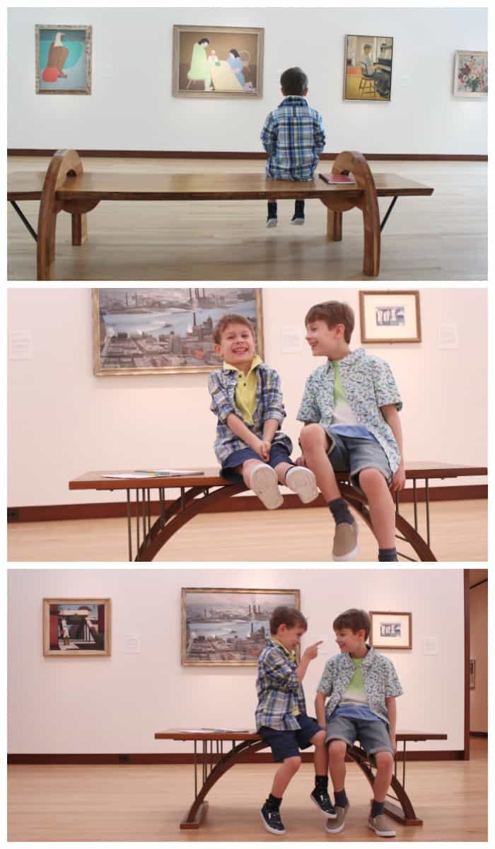 Two kids sitting on a bench laughing