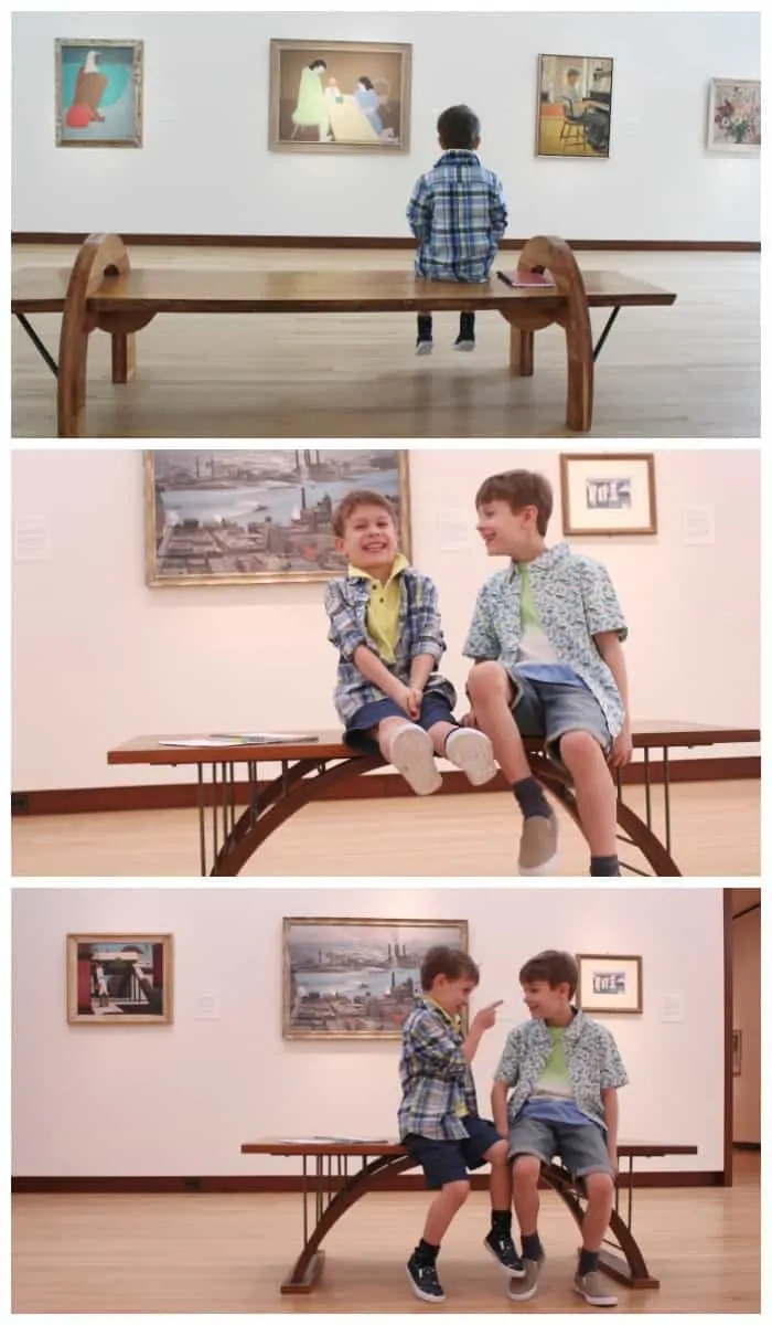 Two kids sitting on a bench laughing