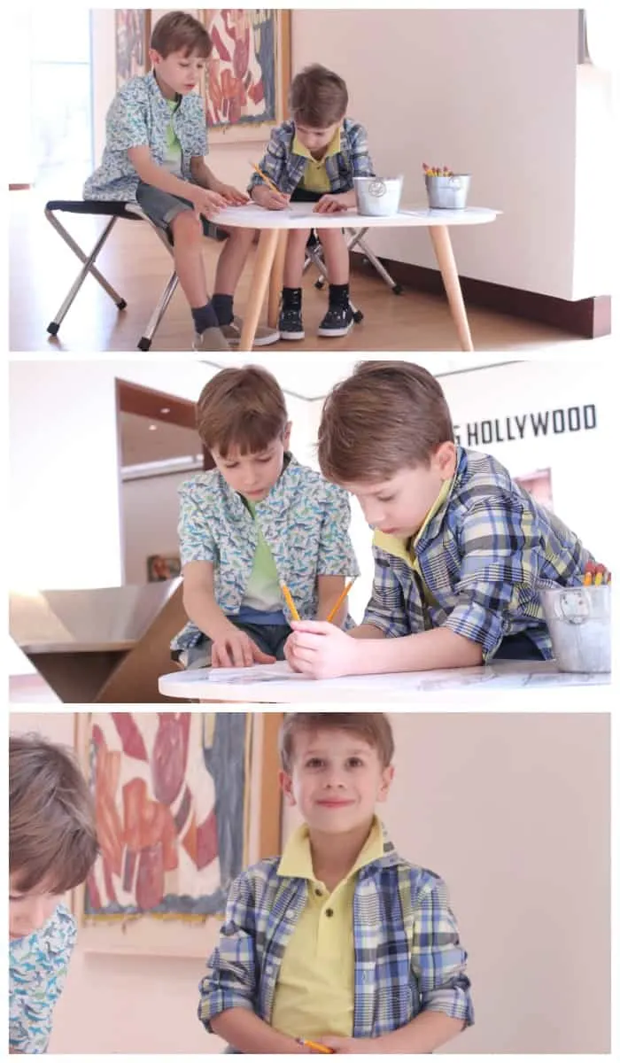 Two kids drawing at a table 