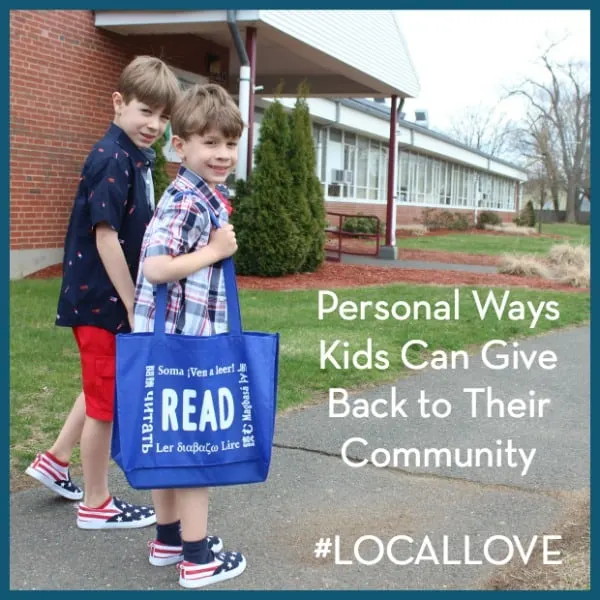 two kids on a sidewalk holding a bag