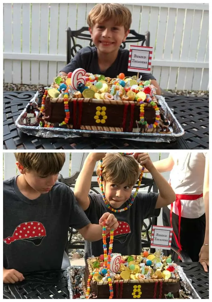 kids celebrate pirate birthday party with candy covered cake