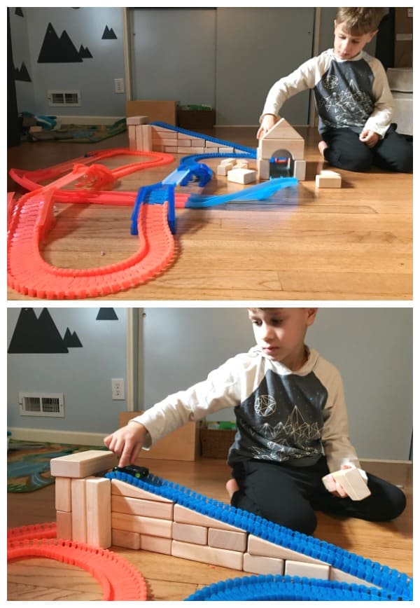 boys playing with toy car tracks