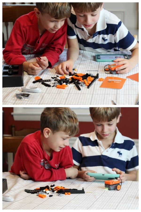 A young boy playing with a robotics toy