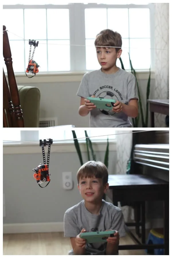 A young boy playing with an Itty Bitty Buggy robot toy