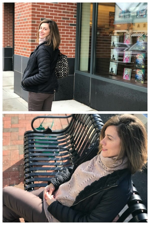 A woman sitting in front of a building