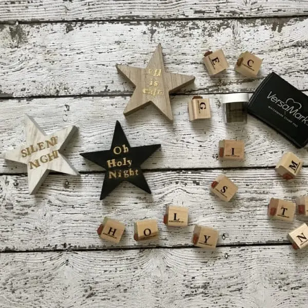 embossed wooden shapes of stars and rubber stamps scattered on table