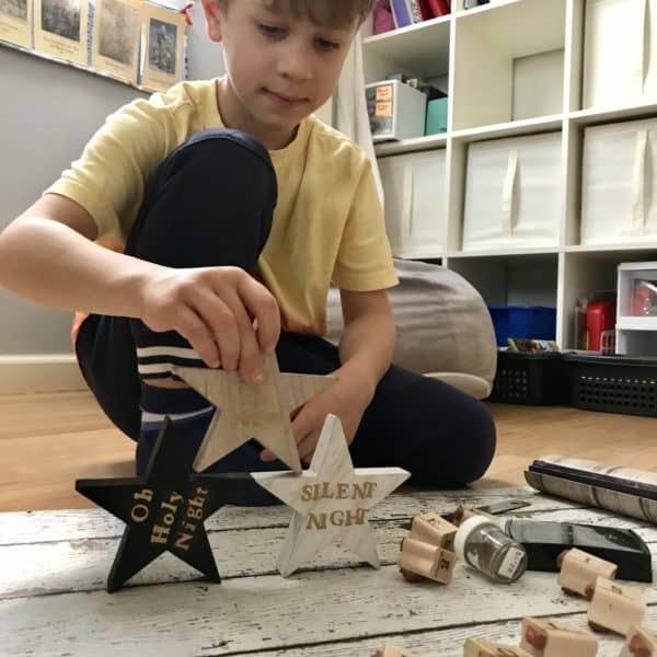 A boy playing with wooden star shapes