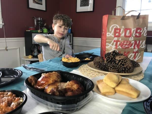 A person sitting at a table with a plate of food