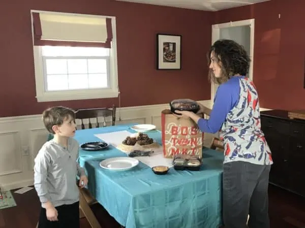 A group of people standing in a kitchen