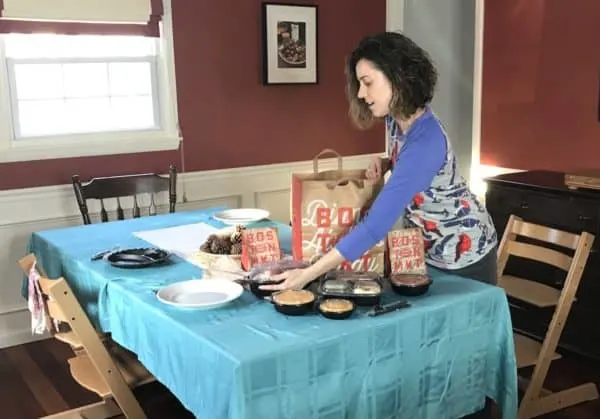 A person setting a table with food