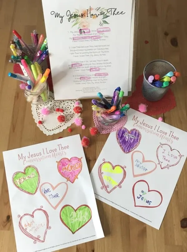 Conversation Hearts Printable Worksheets on a table with markers and Valentine\'s Decorations