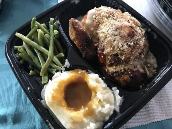 A plastic container filled with different types of food