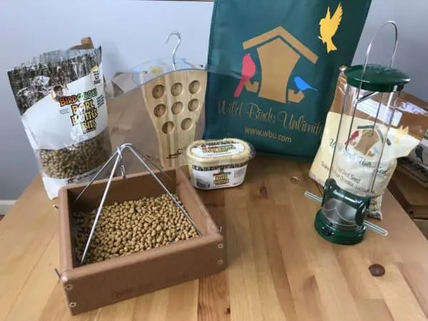 Bird food in feeder on table