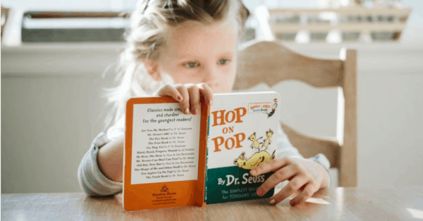 Child reading Hop on Pop Picture book