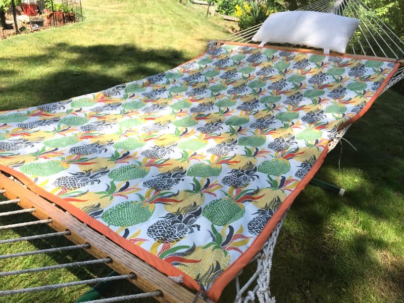 A hammock in a yard covered with a printed DIY Hammock Cover