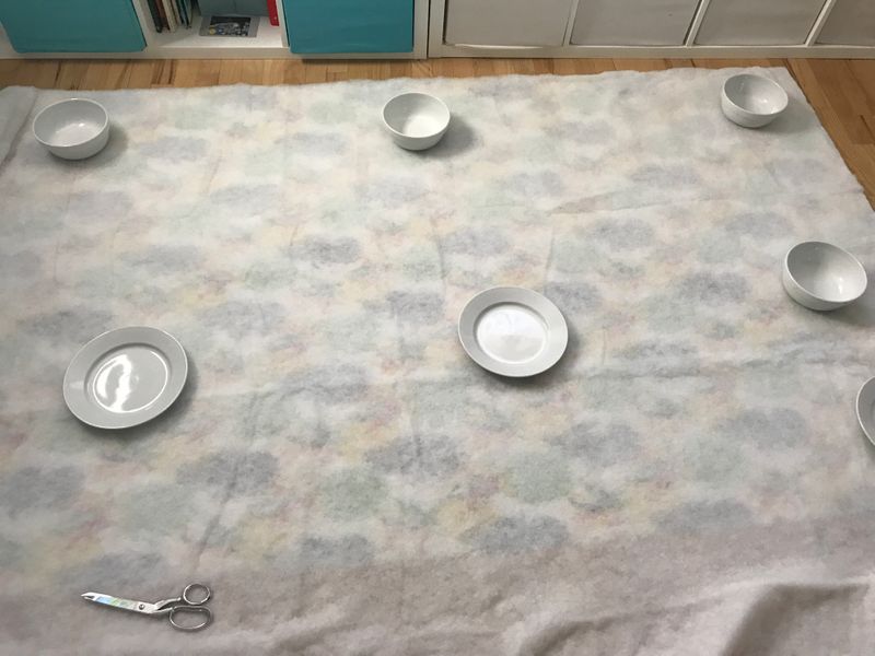 Plates hold down fabric on the floor 