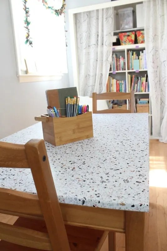 table with bookshelves in background