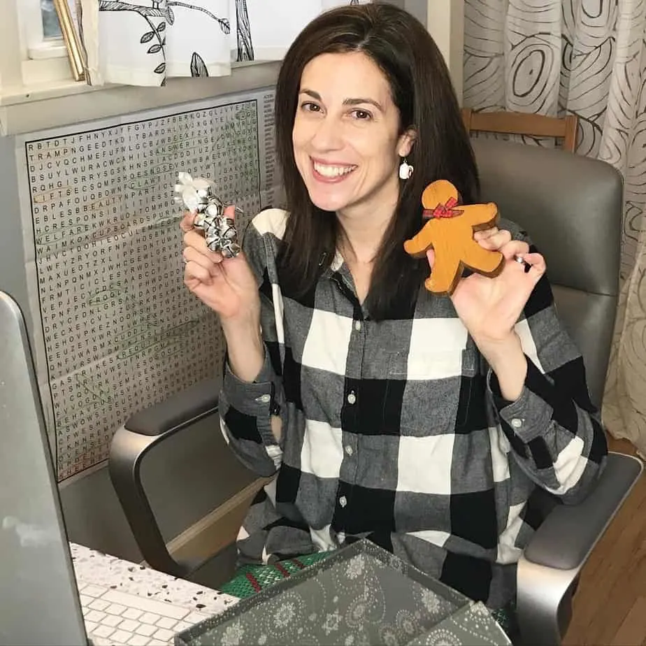 A woman holding a wooden toy posing for the camera