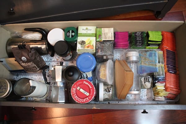 A close up of many items organized in a drawer with bins