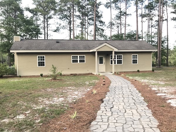 A medium single story vacation house with a stone walkway