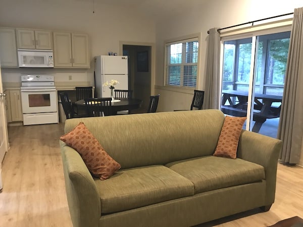 A living room filled with furniture and a large window