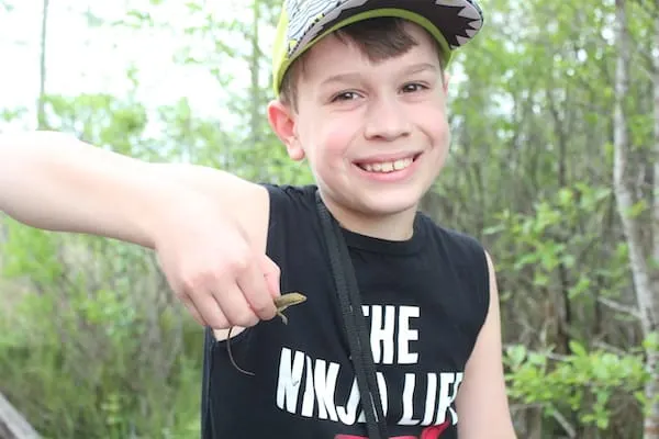 Child wearing a hat and smiling at the camera