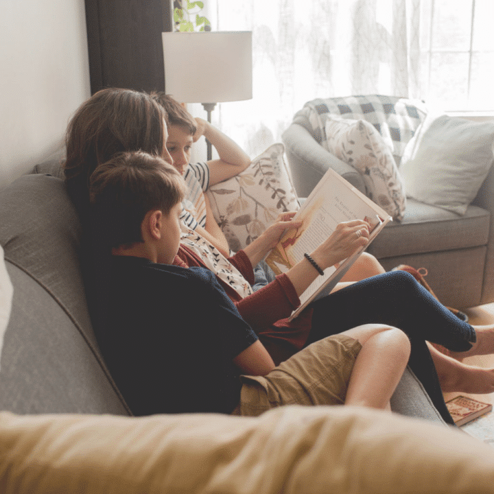 homeschool family reading on the couch in a cozy living room