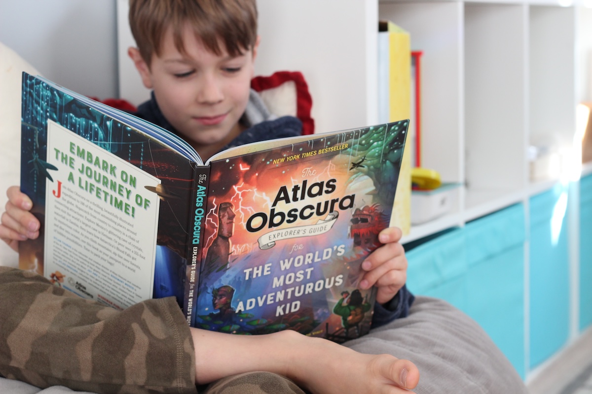 boy reading non-fiction. which can help him become a strong reader