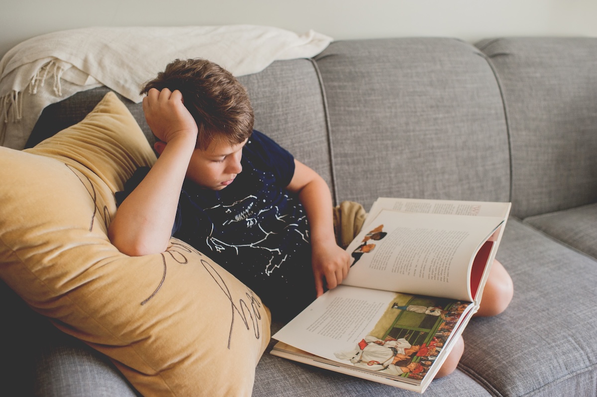 boy reading on the couch
