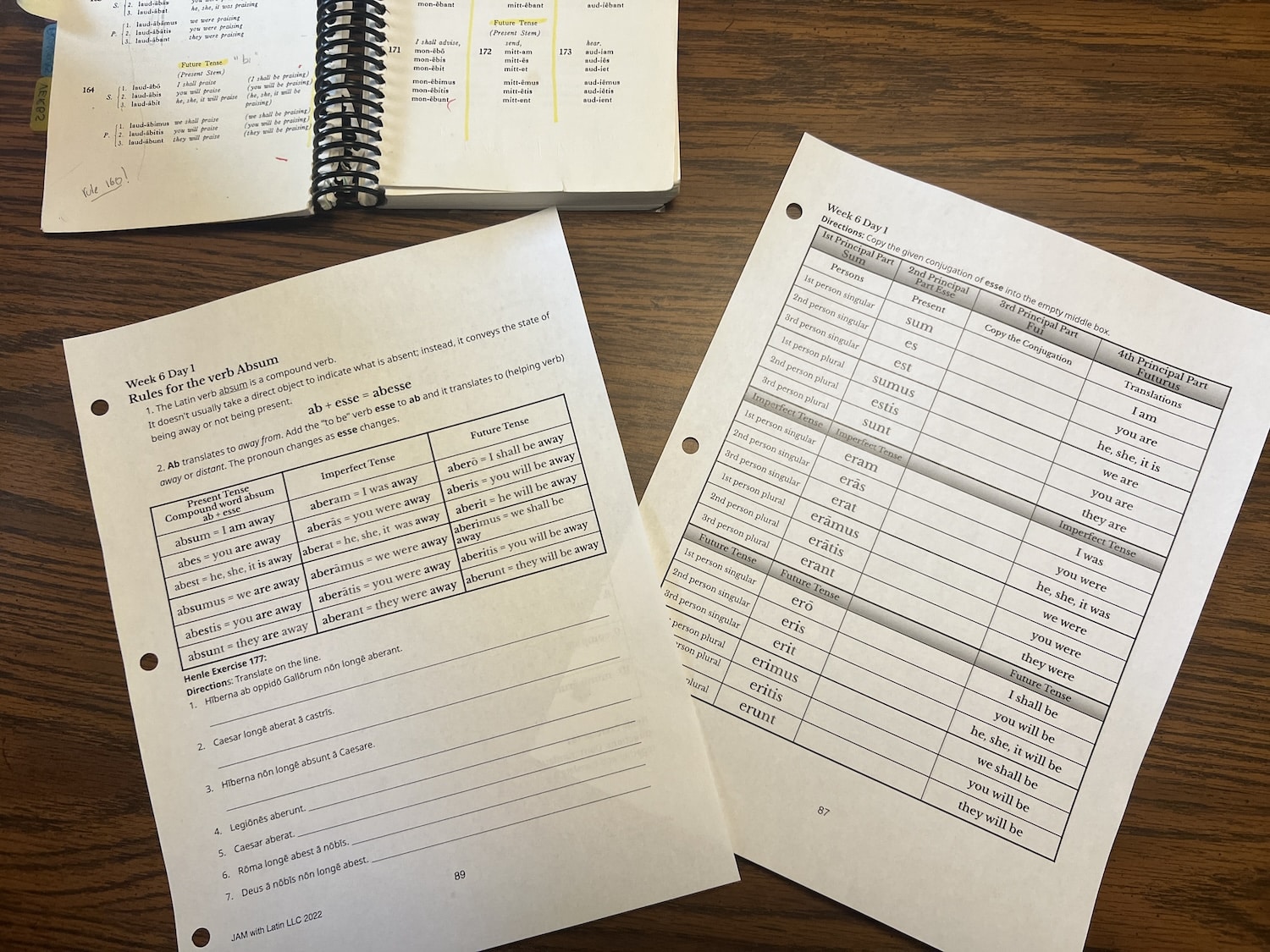 Two Latin worksheets on a table